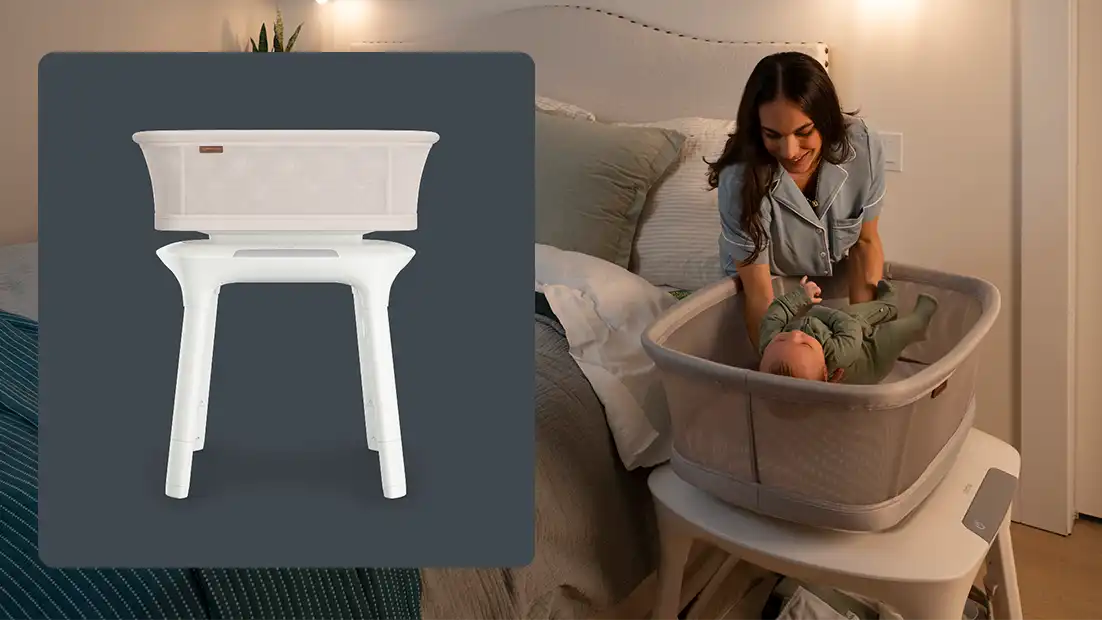 A streamlined white and beige UPPAbaby Soma smart bassinet, shown from a side angle as a standalone in-home product.