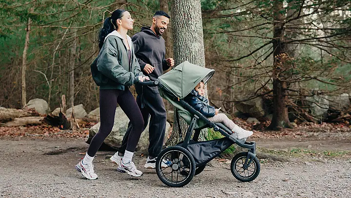 Family walking in the woods with stroller